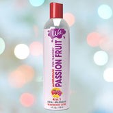 A bottle of Wet "Passion Fruit" Warming Lubricant 🍊 sits against a blurred bokeh background, labeled as a 4-in-1 product designed for oral use, massage, and warming sensations, promising an irresistible twist to your sensory experiences.